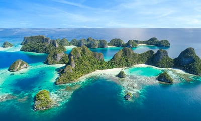 Discover Wayag Island's spectacular limestone karst formations, surrounded by sapphire seas.
