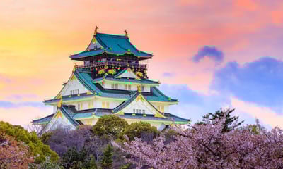 Osaka Castle, Japan rises above the sakura (cherry blossoms).