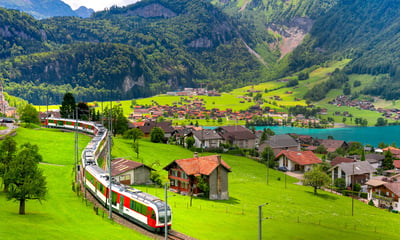Brunig railway line passing through the village of Lungern in Switzerland.