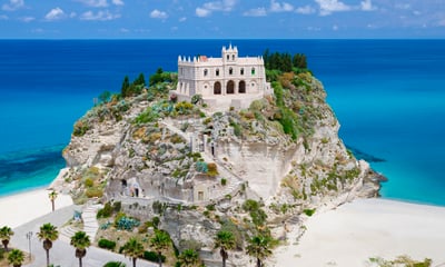Santuario di Santa Maria dell'Isola stands at the top of a hill on Tropea beach in southern Italy.