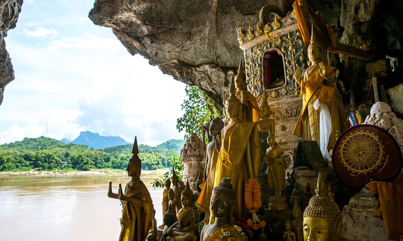 Discover the hidden secrets of the Pak Ou Caves, home to thousands of Buddha statues, Laos.
