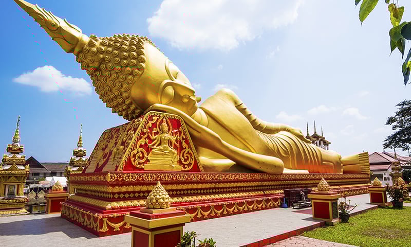 See the reclining golden Buddha, Wat Pha That Luang, Vientiane.