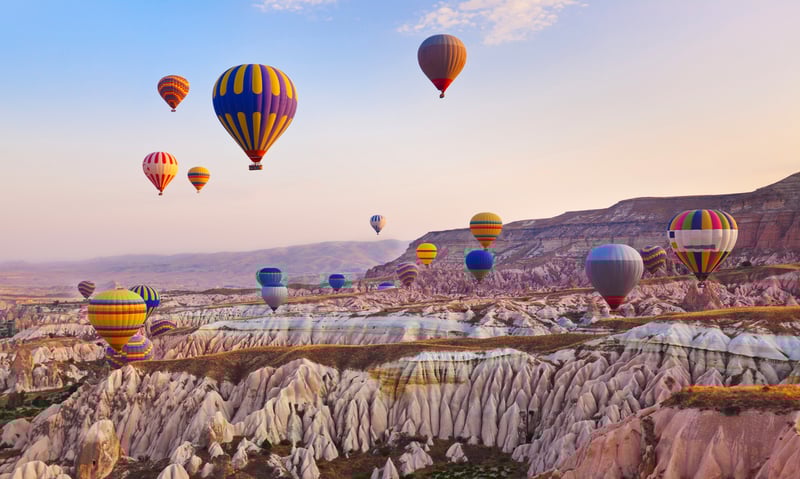 Take part in an optional hot air balloon ride in Cappadocia, Türkiye  (extension package).