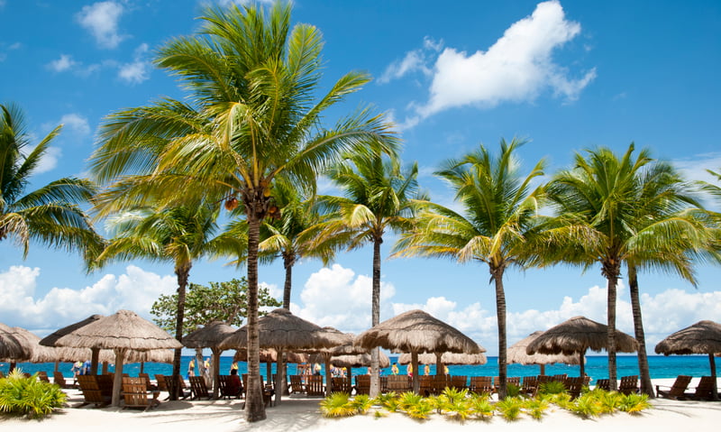 Watch the shimmering ocean from the white sands of Cozumel, Mexico.