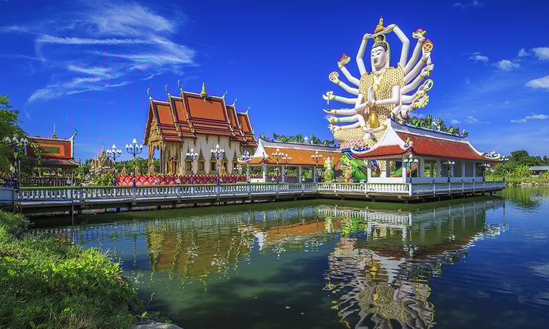 Stand in awe beneath the arms of Koh Samui's Wat Plai Laem Temple.