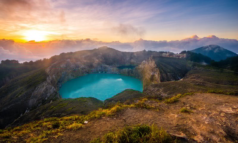 Catch an incredible sunrise at the crater lakes on Mount Kelimutu Crater, Flores.
