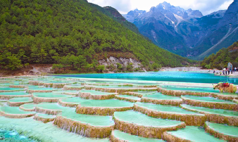 See turquoise rivers and large colourful lakes in Jade Dragon Snow Mountain near Lijiang, China.