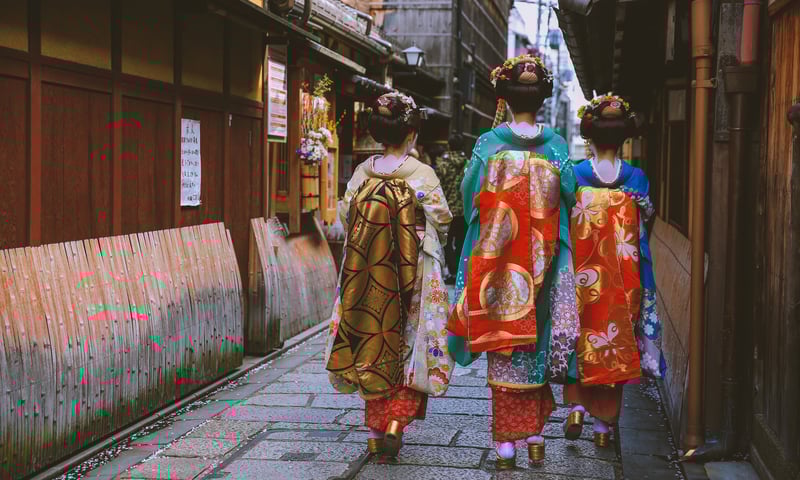 Maikos (apprentice geishas) in a traditional street of Kyoto, Japan.