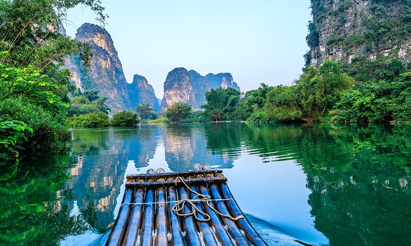 Join an optional bamboo raft activity floating among the timeless landscapes of Guilin.