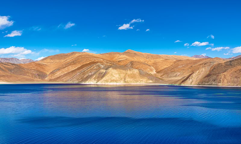 Witness the surreal blue hues of Pangong Lake in Ladakh, India.