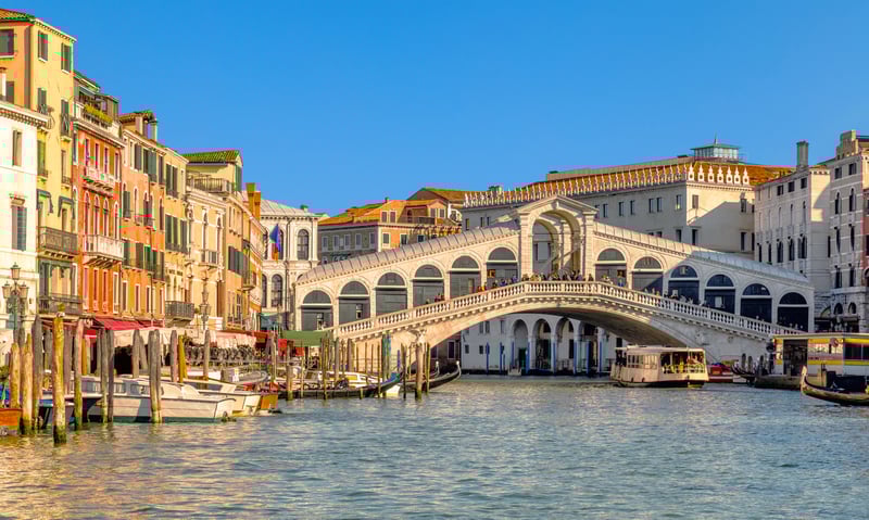 Admire the iconic Rialto Bridge in Venice, Italy.