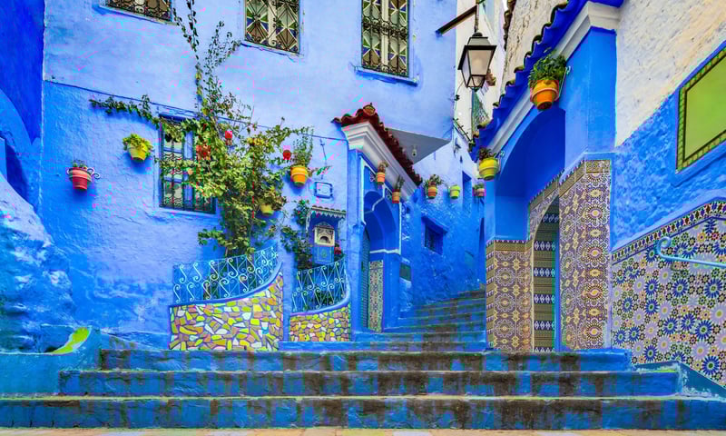 Photograph the blue buildings throughout Chefchaouen, Morocco.