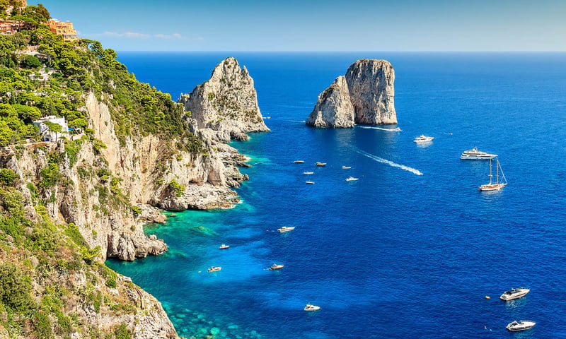 Admire the blue waters surrounding Capri, Italy.