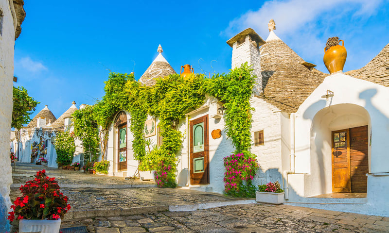 Marvel at the traditional houses in Alberobello, Italy.