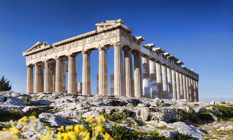 The ancient Parthenon and Acropolis stand high over Athens, Greece.