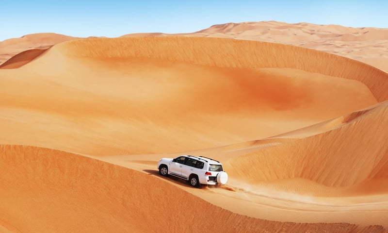 Take a 4x4 safari across rolling desert sand dunes at Wadi Rum, Jordan.