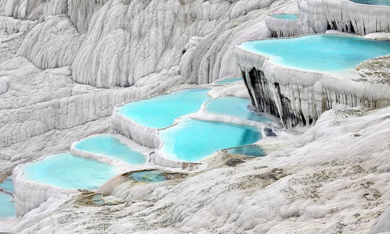 See the calcium terraces (or 'cotton castles") of Pamukkale.