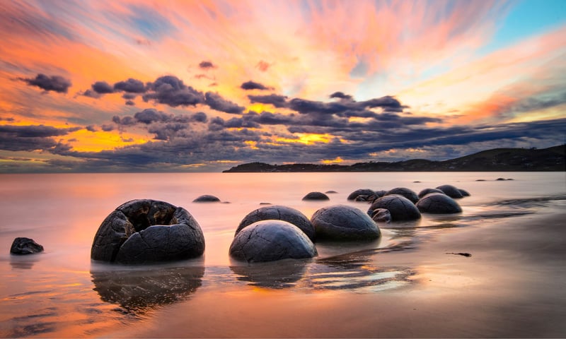 Visit the iconic Moeraki Boulders, a remarkable natural phenomenon scattered along Koekohe Beach.