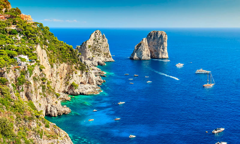 The Faraglioni are Capri's iconic, 100-meter-tall limestone stacks.