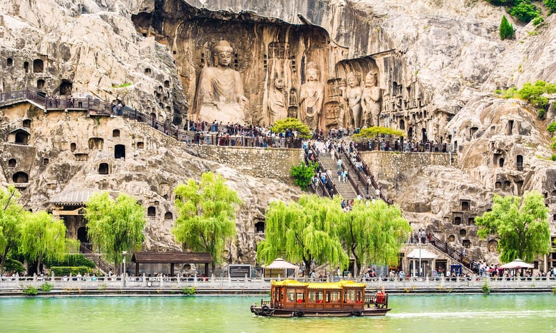 Visit Luoyang to explore the famed Longmen Grottoes.