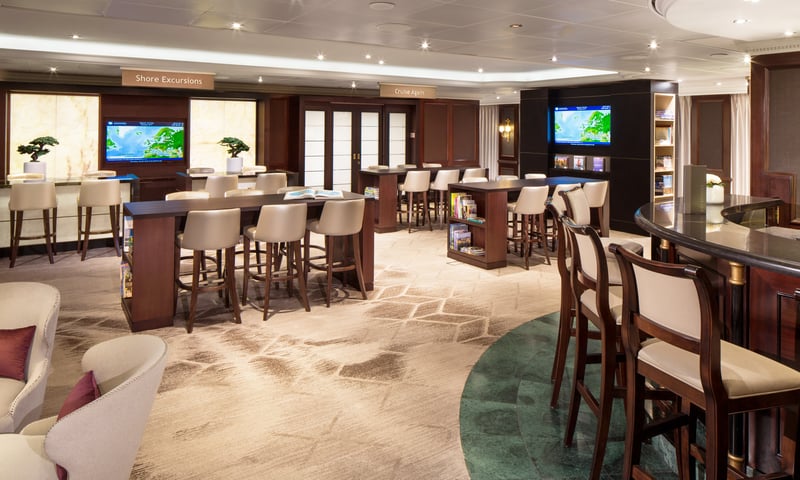 Browse travel books in The Den onboard Azamara Pursuit.
