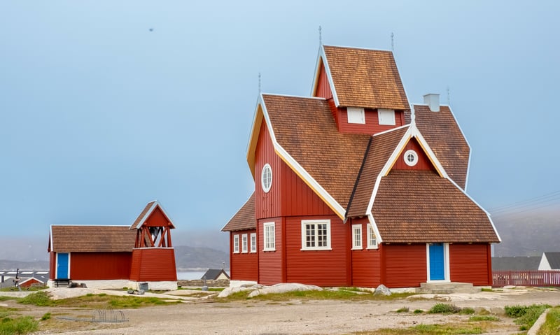 Visit the charming church in Qeqertarsuaq, Greenland (Itinerary 1).