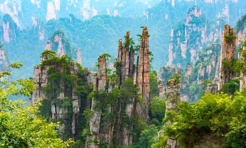 Pillar rock formations and cloudy forested landscapes in Zhangjiajie National Forest Park Gallery.