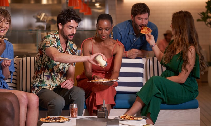 Relax with friends with a slice of goodness at Pizza Place onboard Valiant Lady.