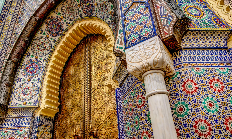 Look for the colourful tiles on the Royal castle gate, Fes, Morocco.