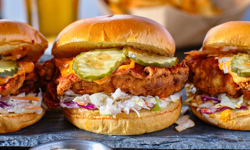 Traditional food of the USA's south includes spicy chicken, slow and  pickles sandwich.