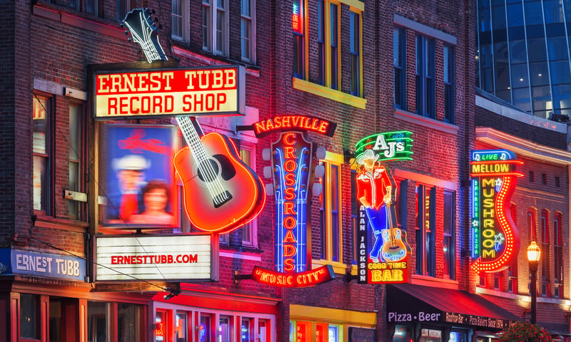 Follow the neon signs of Broadway Street at nighttime in Nashville, Tennessee.