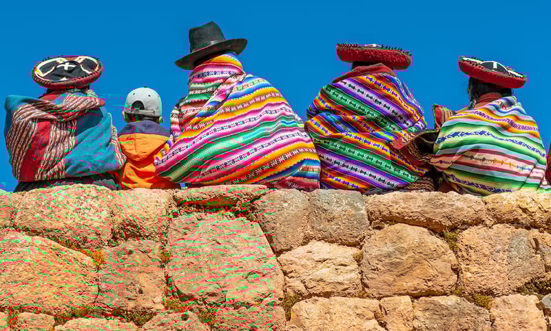Wave to friendly locals in Cusco, Peru.