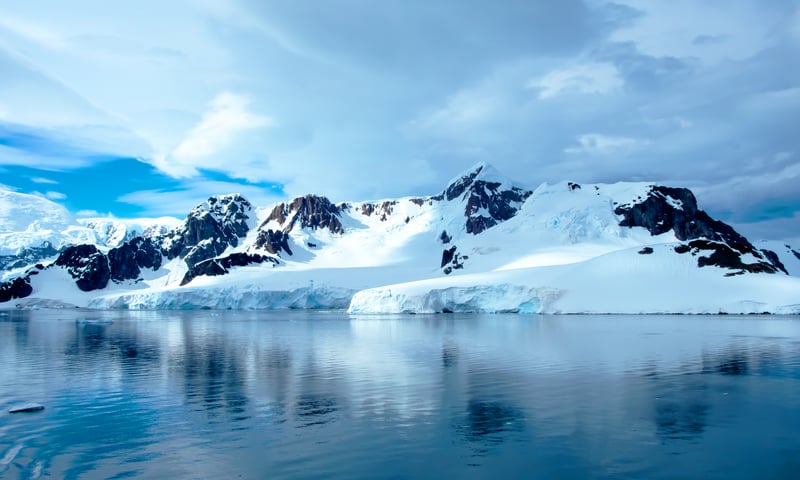 Admire snow-capped mountains on Elephant Point, Antarctica.