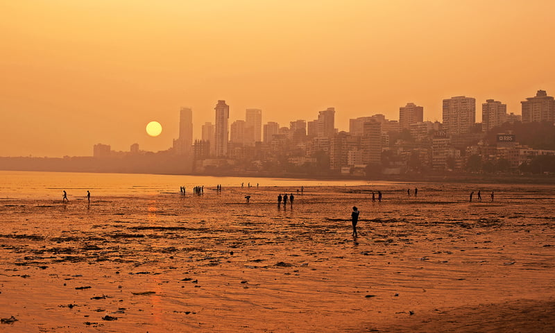 Watch the sun set over Chowpatty Beach, Mumbai.