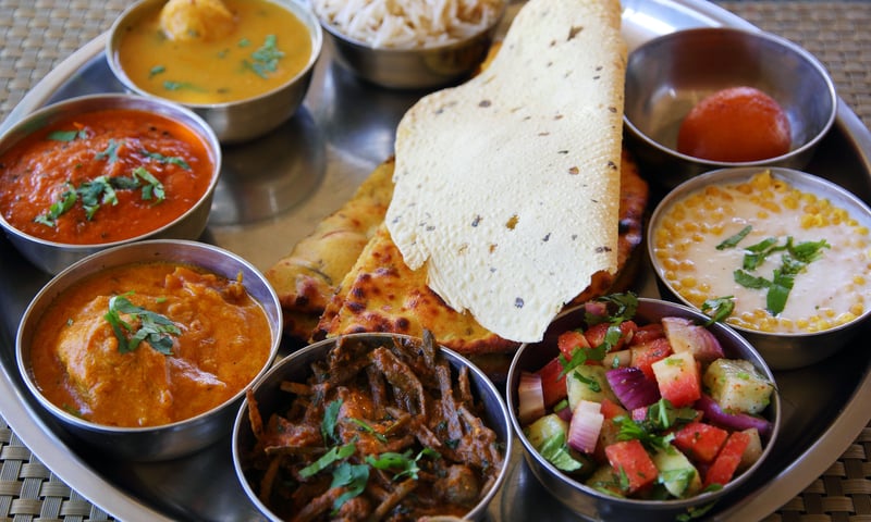 Tantalise your tastebuds with traditional Rajasthani cuisine, India(Charges may apply).