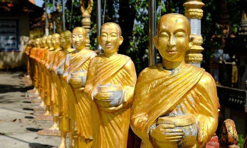 Sihanoukville's Wat Krom golden procession of monks lead you to the immense sleeping golden Buddha.