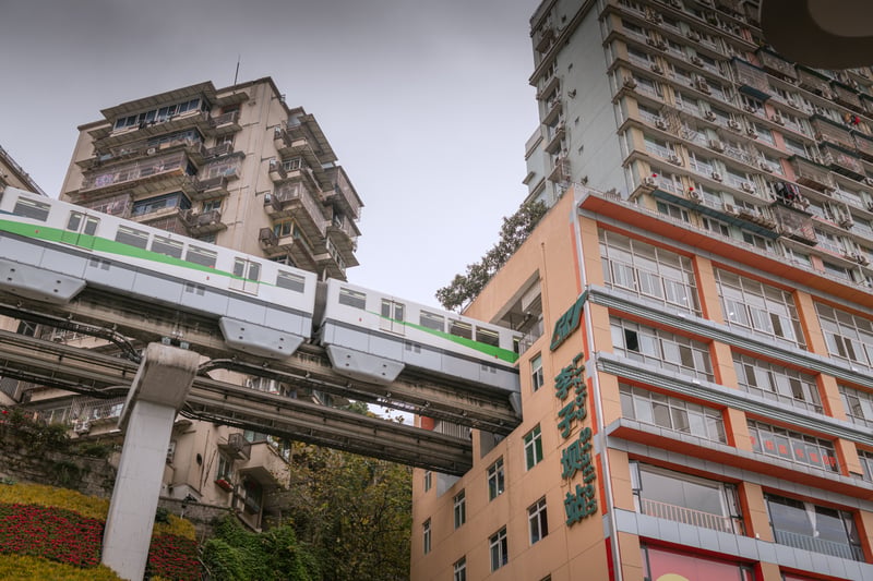 See the city rail go through a residential building in Chongqing.