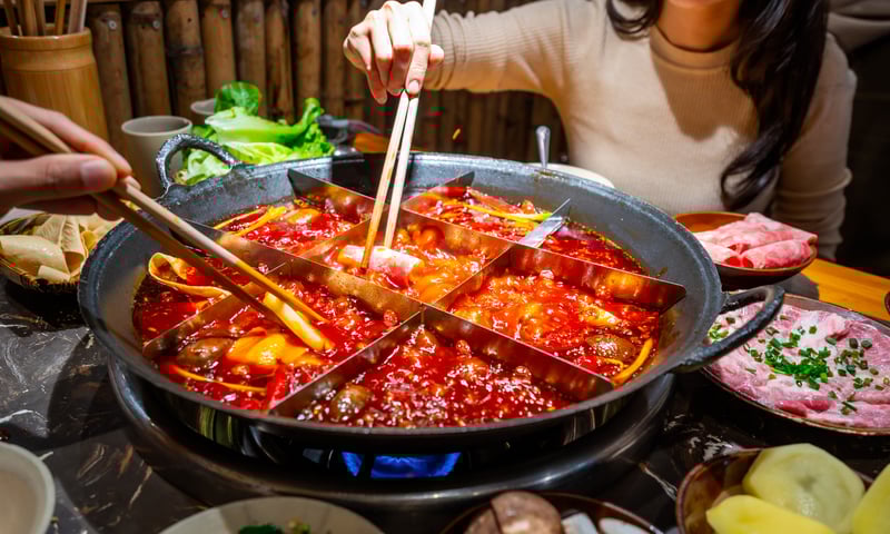 Enjoy a traditional hot pot dinner in Chongqing, China. (Optional activity, charges apply)