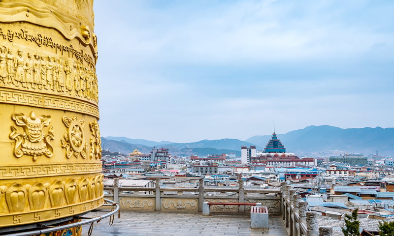 Aerial view if Dukezong Ancient City and prayer wheels in Shagri-La, Yunnan.