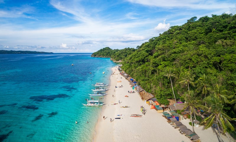 Catch a tender to the island of Boracay, Philippines.