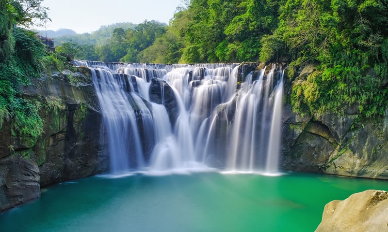 Known as the "Little Niagara of Taiwan", Shifen's waterfall plunges into a deep, jade-green pool.