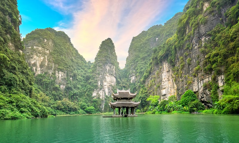 Float on a bamboo boat among the striking limestone karst formations.