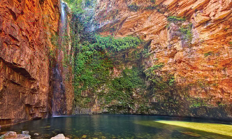 Discover the cool oasis of palms and pandanus tucked into striking red cliffs at Emma Gorge.