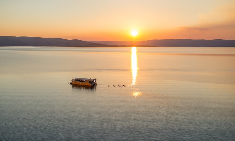 Glide through Lake Argyle's bays and inlets on a Sunset Explorer Cruise.