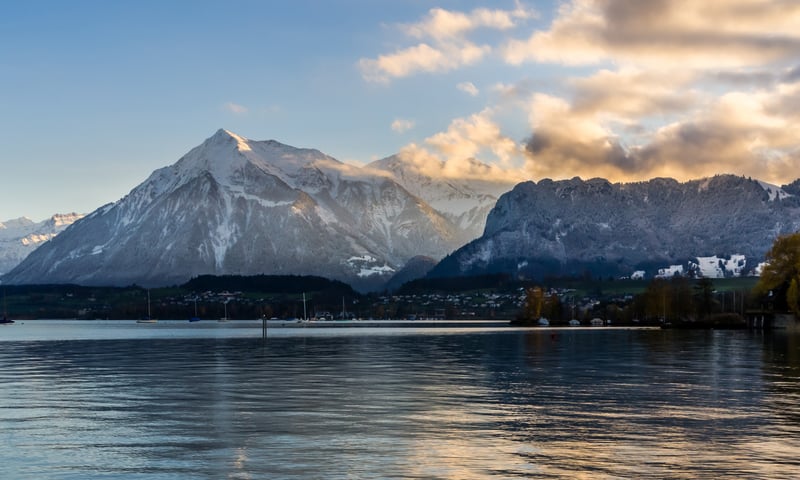 Lake Thun has deep blue, clear water in the Bernese Alps.