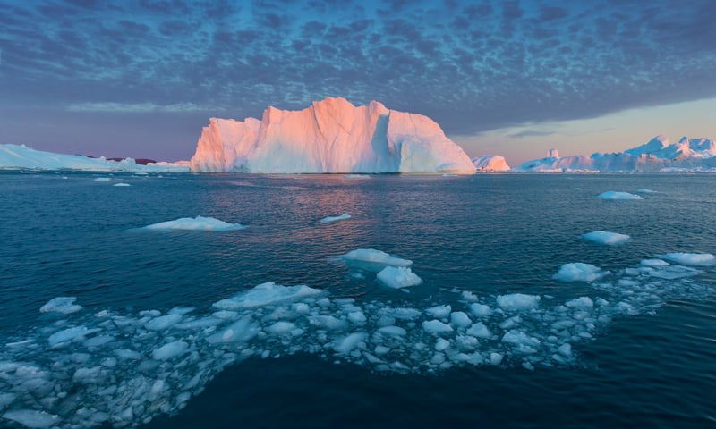 The midnight sun transforms icebergs into colourful light shows on Greenland’s Disko Bay.