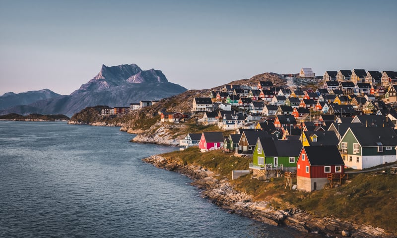 The colourful houses at Nuuk, Greenland brighten up the horizon (itinerary 2 only).