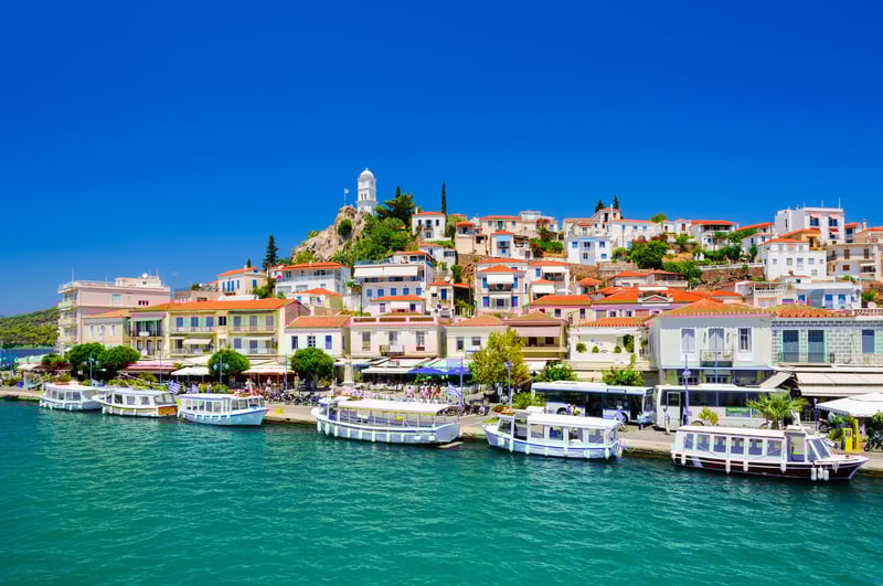 Cruise past Poros one of the Saronic islands.