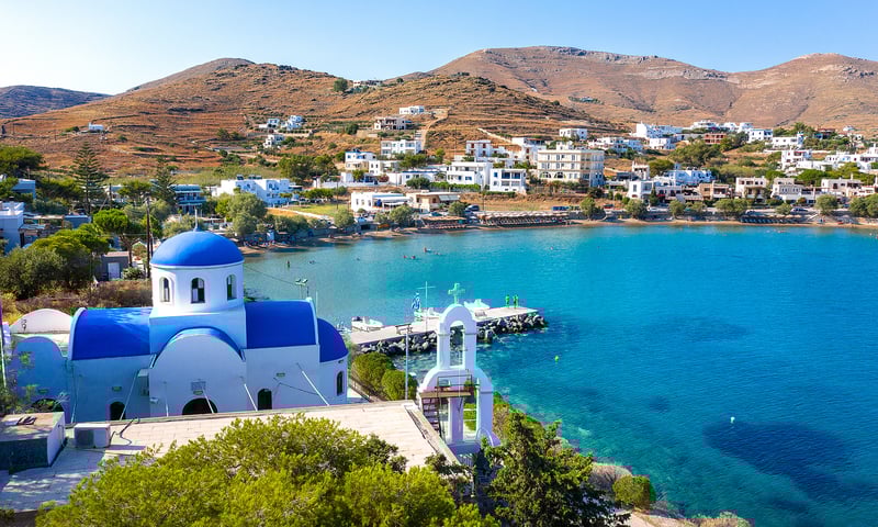 Syros' whitewashed houses form a striking contrast against the blue Aegean Sea.