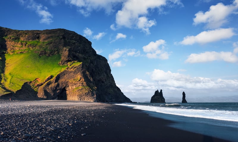 Stroll the black lava beach at Reynisfjara, Iceland.
